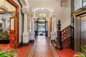 a hallway of a building with a chandelier at Quality Inn The George Hotel Ballarat in Ballarat