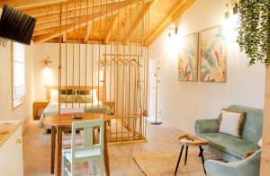 a living room with a bed and a table at Villa Garcia in Terras de Bouro