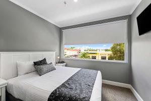 a bedroom with a bed and a large window at CH Boutique Hotel, Ascend Hotel Collection in Tamworth