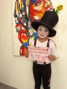 a young child wearing a cowboy hat holding a sign at Segovia apartment in Bogotá