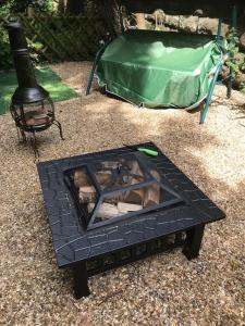 a black coffee table with a grill and a tent at The Old Post Office, Knaresborough in Knaresborough