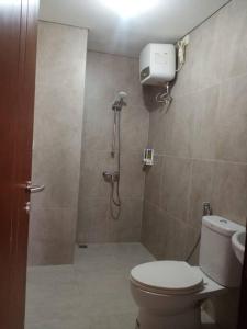 a bathroom with a shower and a toilet at Flysleep Apartemen Pollux Habibie Batam Centre 2BR Sea in Sengkuang