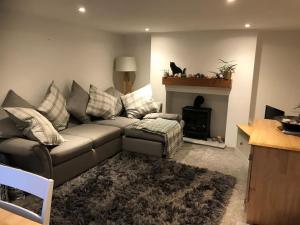 a living room with a couch and a fireplace at The Old Post Office, Knaresborough in Knaresborough