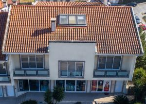 an overhead view of a white house with an orange roof at Casa da Barragem in Marco de Canaveses