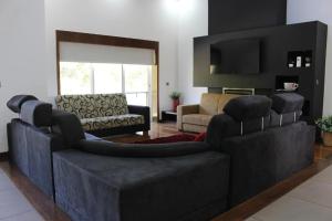 a living room with two couches and a television at Casa da Barragem in Marco de Canaveses