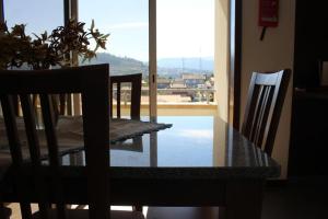 a dining room table with a view of a balcony at Casa da Barragem in Marco de Canavezes +16 photos