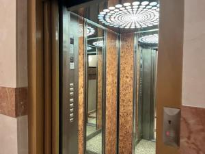 a glass door of a building with a ceiling at Habitaciones con cama de matrimonio en Mislata by Alterhome in Valencia