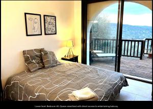 a bedroom with a bed with a view of a deck at Villa Robinson Belvedere in Montauroux +31 photos
