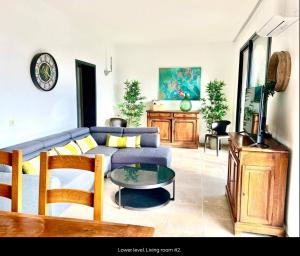 a living room with a blue couch and a table at Villa Robinson Belvedere in Montauroux