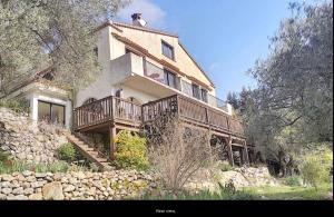 a large house on a hill with a stone wall at Villa Robinson Belvedere in Montauroux