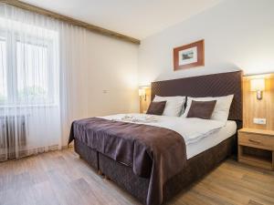 Postel nebo postele na pokoji v ubytování EA Hotel Lipno