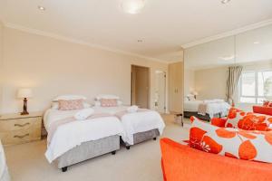 a large bedroom with two beds and a couch at Fifty1 on Long on Kingswood Golf Estate in George