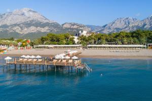 a pier with chairs and umbrellas on a beach at Seven Seas Hotel Life - Ultra All Inclusive & Kids Concept in Kemer