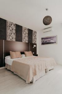 a bedroom with a large bed in a room at Mare Hotel in Dos Hermanas