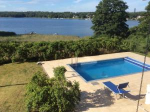 a swimming pool with a view of a lake at Exklusive rental of the Entire Spacious Ground Floor in Sollentuna