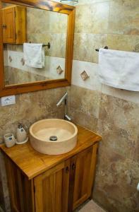 a bathroom with a sink and a mirror at Cabana din poiană in Câmpulung Moldovenesc