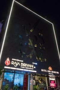 a building with a sign in front of it at night at KRR Grand inn in Coimbatore