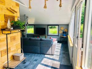 a living room with a couch and a tv at Beautiful house on an island near Amsterdam 