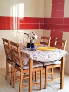 a dining room table with a table cloth and chairs at VILLA ANDORINHA with Private Pool in a quiet area in Aljezur