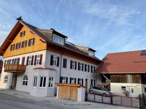 a large white building with a red roof at Beim Forchi in Marktoberdorf