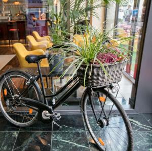 a bike with a basket with plants in it at ARCOTEL Velvet Berlin in Berlin
