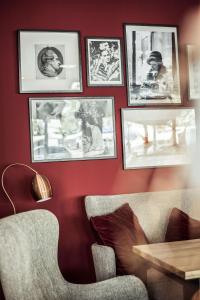 a room with a couch and pictures on the wall at ARCOTEL Velvet Berlin in Berlin