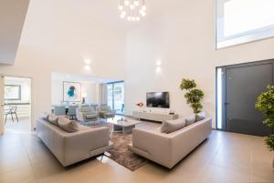 a living room with two couches and a tv at Villa Aboim - BY BEDZY in Guia