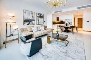 a living room with a couch and a table at Elegant family apartment in Marina Vida Residence in Dubai