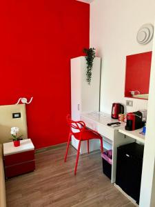 a red kitchen with a desk and a red wall at Pope's bridge in Rome