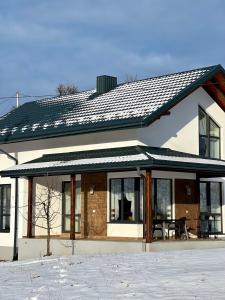 a house with a solar roof on top of it at Villa Pelahia in Slavske