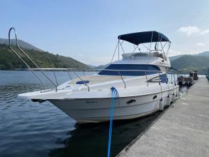 a boat is docked at a dock in the water at AQUADOURO Yacht RADAMES - Sleep Boat Experience in Castelo de Paiva