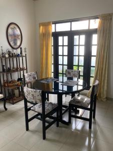 a dining room with a black table and chairs at Mirihana Residence in Nugegoda