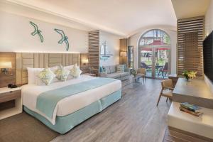 a bedroom with a large bed and a living room at JA Palm Tree Court, Dubai in Dubai +94 photos