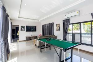 a living room with a pool table in it at Villa ABBIE ! Amazing Pool Villa for family and Friends in Hua Hin