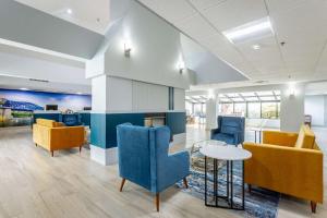 a lobby with blue chairs and a table in a building at Comfort Inn & Suites Chattanooga-East Ridge in Chattanooga