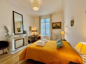 a bedroom with a bed with towels on it at L’Hôtel Particulier des Anges in Reims +20 photos