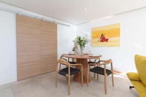 a dining room with a wooden table and chairs at L'Aiglon By SCLS Locations in Vallauris