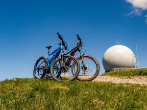 two bikes parked on top of a hill with a dome at Berghotel Deutscher Flieger Wasserkuppe in Gersfeld