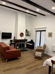 a living room with a couch and chairs and a tv at Ninho do Melro II - Turismo Rural Bragança in Bragança