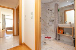 a bathroom with a sink and a toilet in a room at Buarcos Ocean Village in Buarcos +54 photos