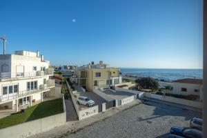 a view of the ocean from the balcony of a building at Buarcos Ocean Village in Buarcos