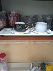 a counter with two cups and plates on it at Hisar Apartments in Istanbul