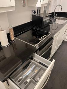 a kitchen with a stove and a counter top at South Kensington one Bedroom Flat in London
