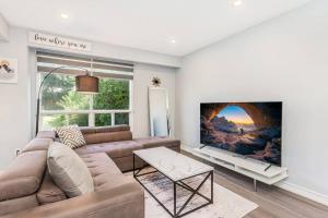 a living room with a couch and a large painting on the wall at Upscale 3BR/2.5BATH House +Games room and Yard! in Mississauga