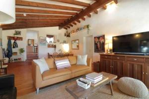a living room with a couch and a flat screen tv at Stunning fazenda w/ beautiful pool and privacy 