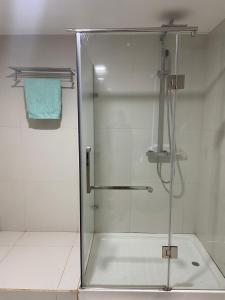 a shower with a glass door in a bathroom at NICE DUPLEX, PRAIA in Praia
