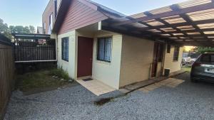 a house with awning on the side of it at Casa Huedhued in Villarrica +9 photos