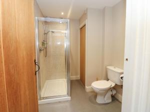 a bathroom with a toilet and a glass shower at The Tithe Barn in Barnard Castle +38 photos