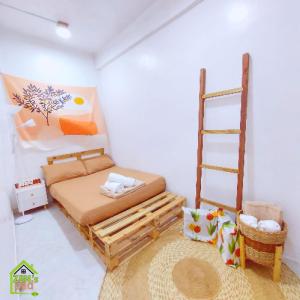 a bedroom with a bed and a ladder at Manila 1BR Cozy Homestay near UST/San Lazaro in Manila