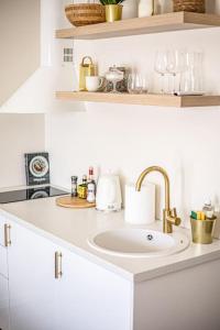 a white kitchen with a sink and a counter at Järvevaatega apartment in Viljandi
